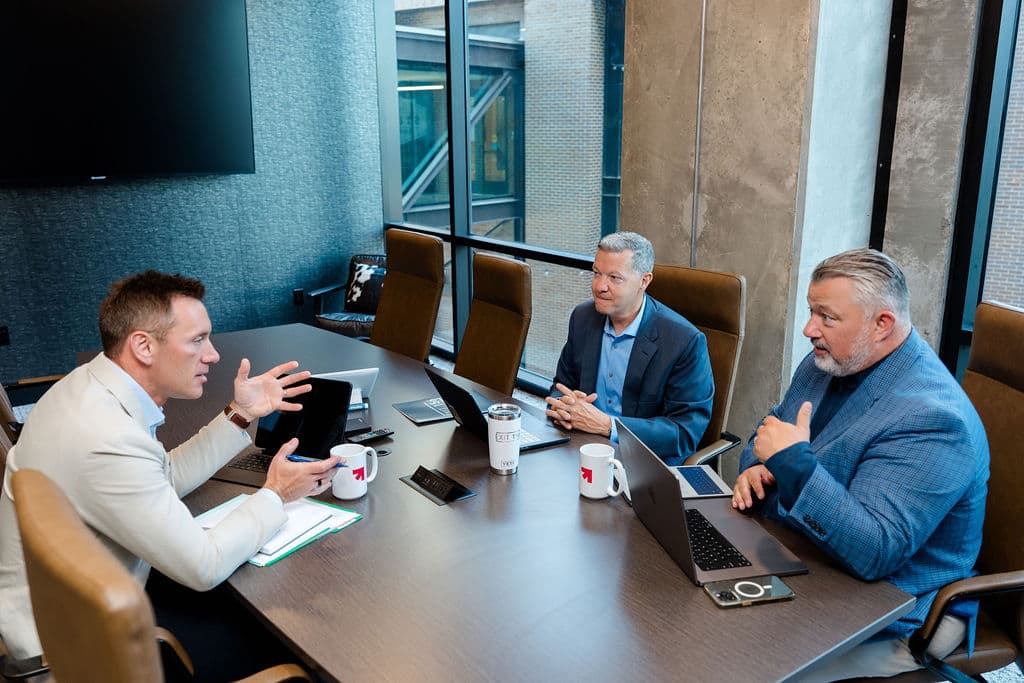Josh Robinson, Mike Nathan, and Brian Kueppers in a working session at Exit 156 Capital